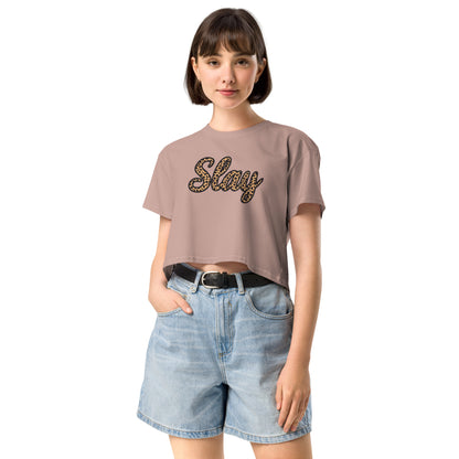 hazy pink Slay crop top styled with high-waisted denim shorts