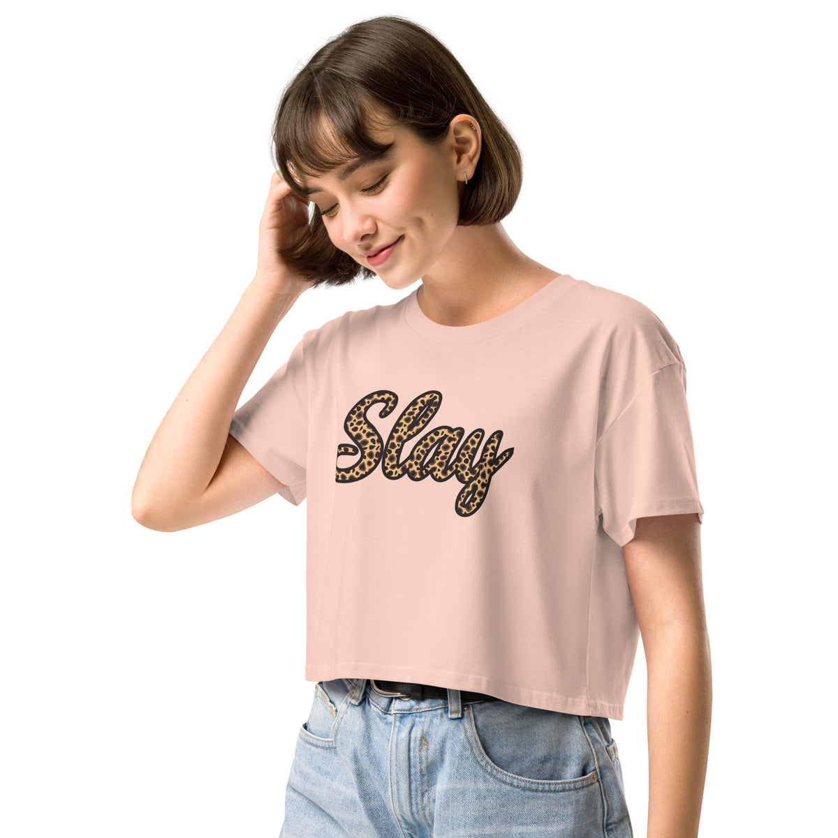 Pale pink Slay crop top styled with high-waisted jeans