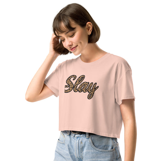 Pale pink Slay crop top styled with high-waisted jeans